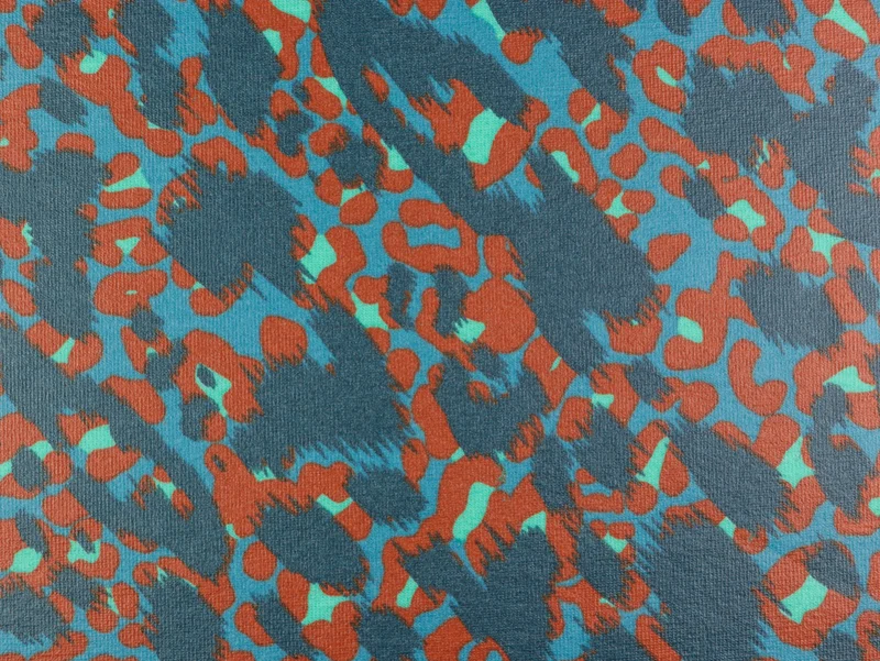 Beschichteter Jersey Reiko Leoprint blau-bunt